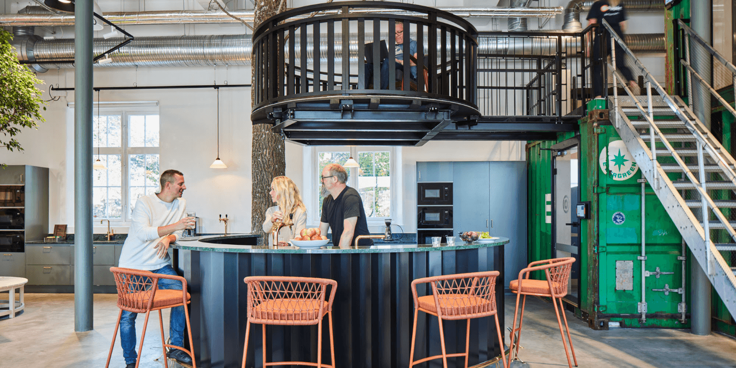 Specialbyggd bar och upphöjt mötesrum i container – visar Frembergs förmåga att lösa unika önskemål i kontorsmiljöer.